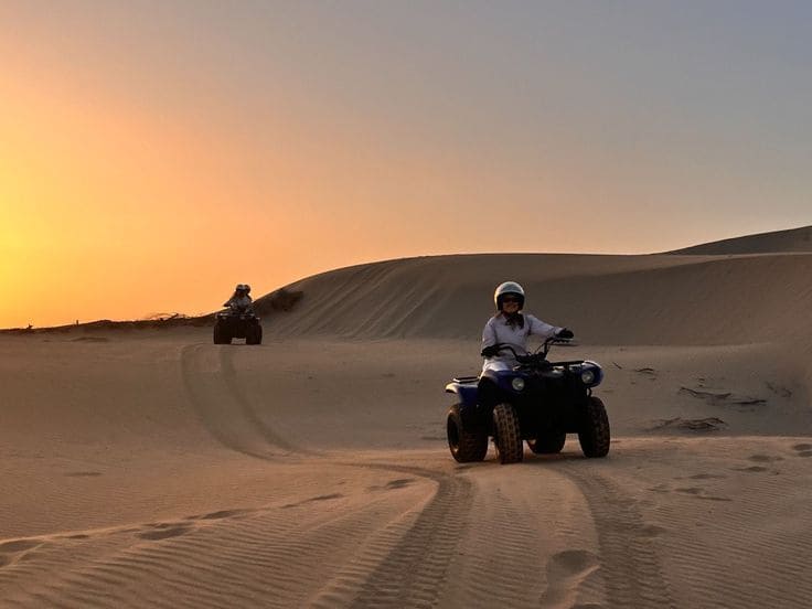 Person riding a quad bike through Moroccan desert landscape